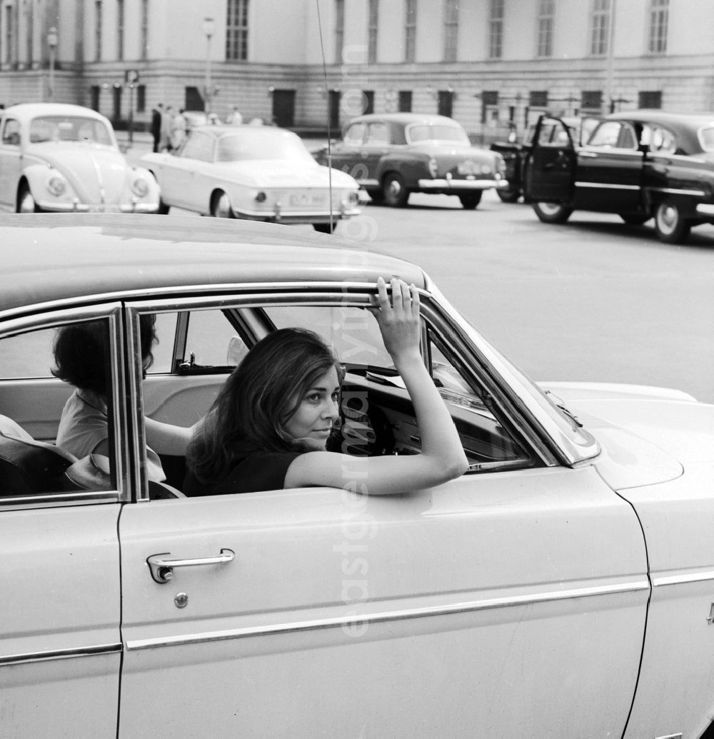 GDR image archive: Berlin - Tourists in Austria are in a Ford Taunus 12M Coupe traveling on the Unter den Linden boulevard in the center of Berlin, the former capital of the GDR, the German Democratic Republic