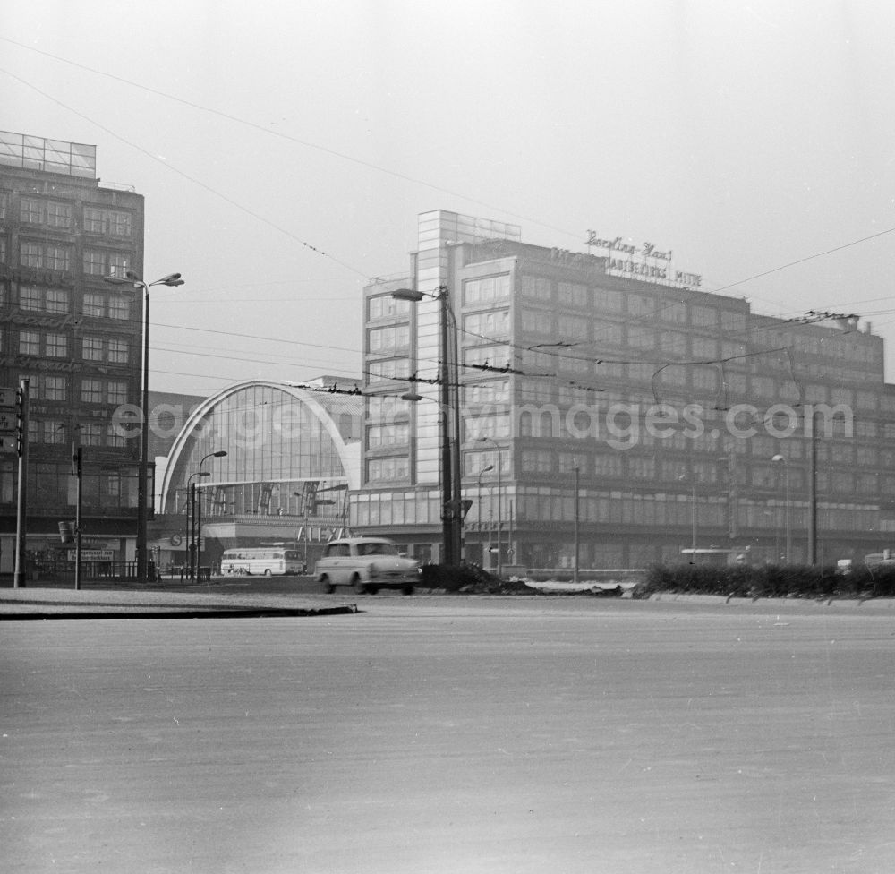 GDR image archive: Berlin - A Trabant in the roundabout at Alexanderplatz in Berlin, the former capital of the GDR, German Democratic Republic. In the background the station Alexanderplatz and the Berolinahaus