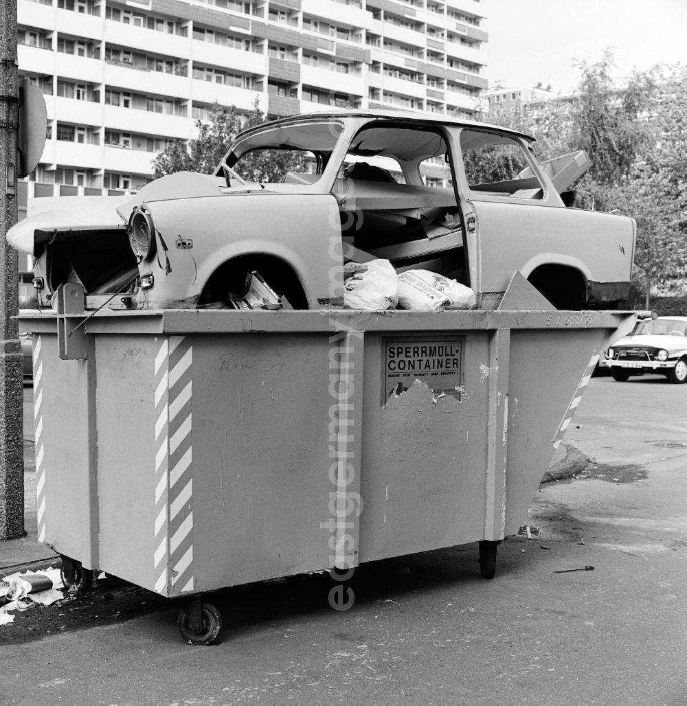 GDR picture archive: Berlin - A Trabant was disposed of in a bulky waste container on the side of a road in Berlin - Mitte