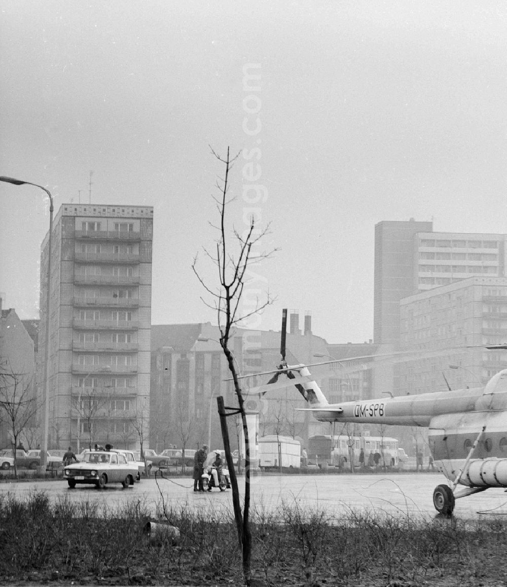 GDR photo archive: Berlin - A transport, load helicopter Mil Mi-8 of the INTERFLUG, with the call sign DM-SPB is refuelled on a parking bay, in Berlin, the former capital of the GDR, German democratic republic