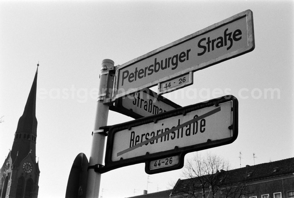 GDR photo archive: Berlin - A new street sign shows the renaming of Bersarinstrasse in Petersburger Strasse on the corner Strassmannstrasse in Berlin - Friedrichshain, the former capital of the GDR, German Democratic Republic
