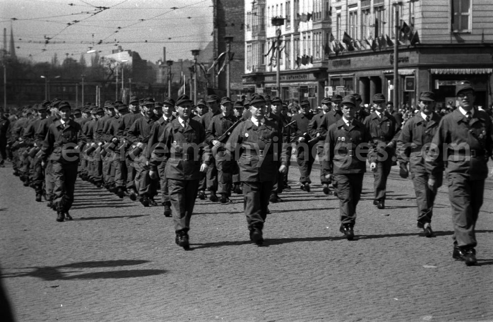 GDR photo archive: Magdeburg - Uniformed units of the combat groups of the working class in the parade in Magdeburg in Saxony-Anhalt. Here at the parade on 1 May. The battle groups of the working class struggle groups were a paramilitary organization of workers in companies in the GDR. The armament of the combat groups consisted among other things of machine guns of the type PPSh-41