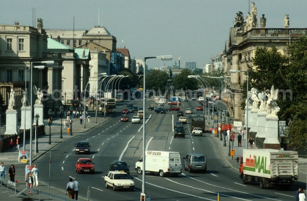 GDR image archive: Berlin - Mitte - Unter den Linden with views towards the Brandenburg Gate in Berlin - Mitte with the 8 figures of Karl Friedrich Schinkel in marble at the castle bridge in the foreground. Links the German State Opera, Komische Oper and others. On the right the Museum of German History. In the middle of the road the equestrian statue of Frederick the Great