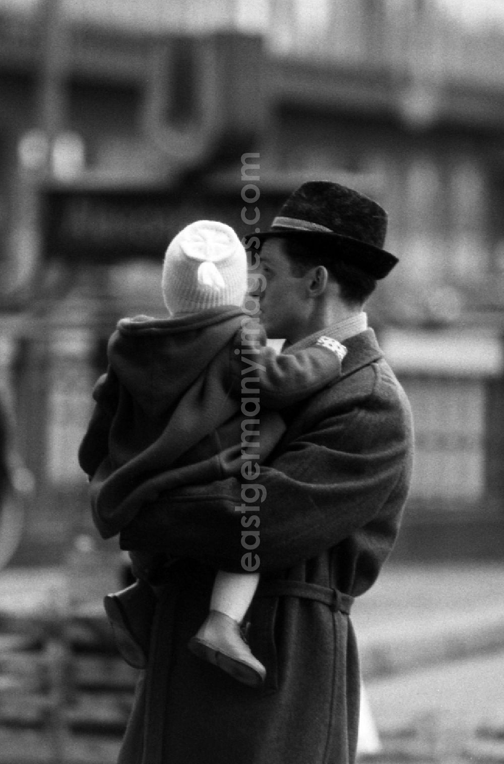 GDR image archive: Berlin - Father holds his child in his arms in East Berlin in the territory of the former GDR, German Democratic Republic