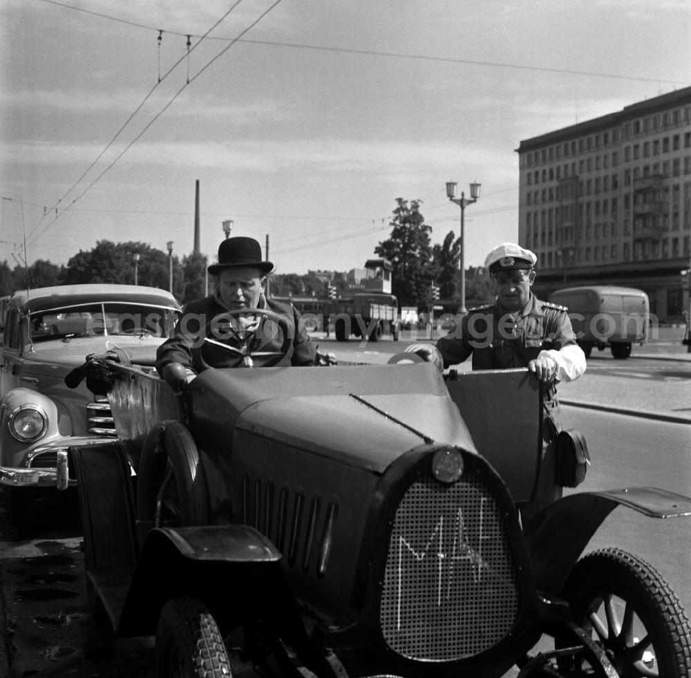 GDR image archive: Berlin - Traffic policeman next to a vintage F5 car from the automobile manufacturer MAF in East Berlin in the territory of the former GDR, German Democratic Republic