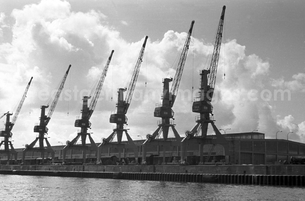 GDR picture archive: Rostock - Loading cranes in the seaport of Rostock in Mecklenburg - Western Pomerania. By the division of Germany resulted in the need to build on the Baltic coast of East Germany a seaport. The new port was opened on 30 April 196