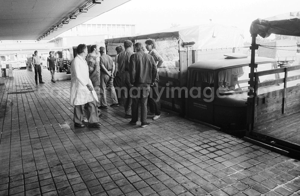 GDR photo archive: Berlin - Employees of the milk court VEB Berlin load in the loading ramp pickup van with milk products in Berlin, the former capital of the GDR, German democratic republic