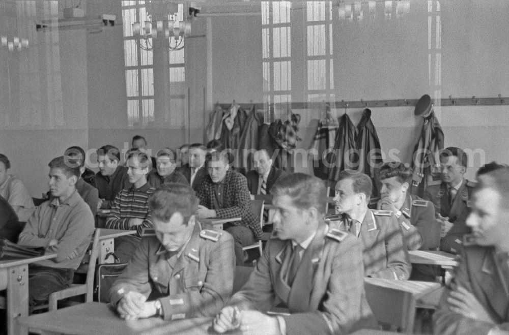 GDR photo archive: Berlin - Meeting of young FDJ members of the vocational school of the VEB Elektro-Apparate-Werke with representatives of the patent group of the border troops for the naming of Siegfried Widera in the classroom in the district of Treptow in Berlin East Berlin on the territory of the former GDR, German Democratic Republic