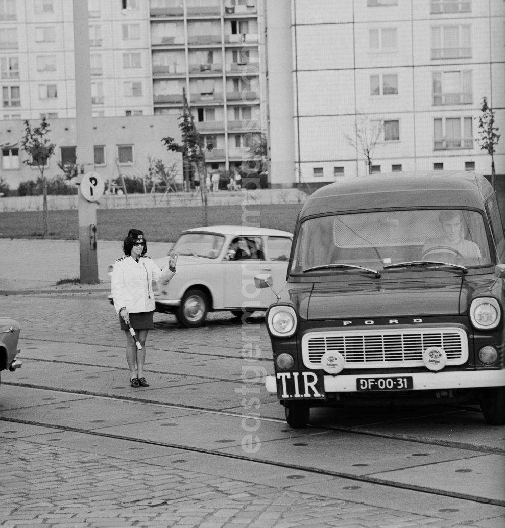 GDR photo archive: Berlin - Mitte - A popular police officer early seventies in Berlin - Mitte in the traffic control. In foreground a Ford Taunus Transit with French license plates