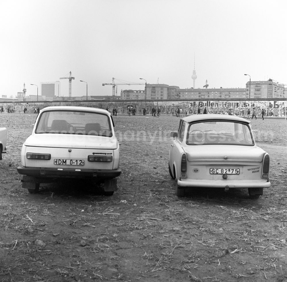 GDR photo archive: Berlin - View over cars of type Wartburg and Trabant also called Trabi on the Potsdamer Platz in Berlin in the direction of the Berlin Wall, residential buildings, and TV Tower in East Berlin