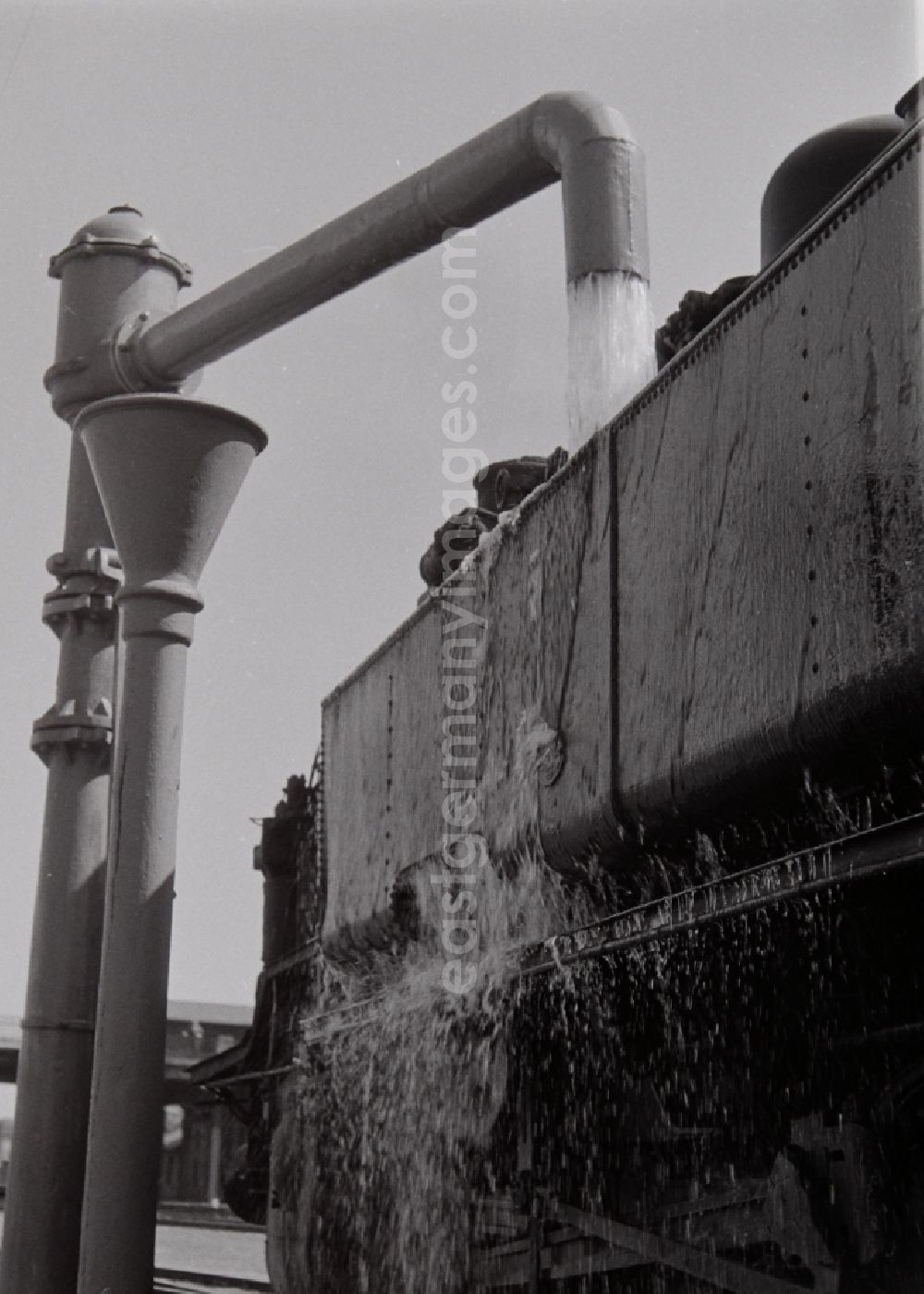 GDR image archive: Halberstadt - Filling at the water crane of a steam locomotive class 93 of the German Reichsbahn in Halberstadt in the federal state of Saxony-Anhalt on the territory of the former GDR, German Democratic Republic
