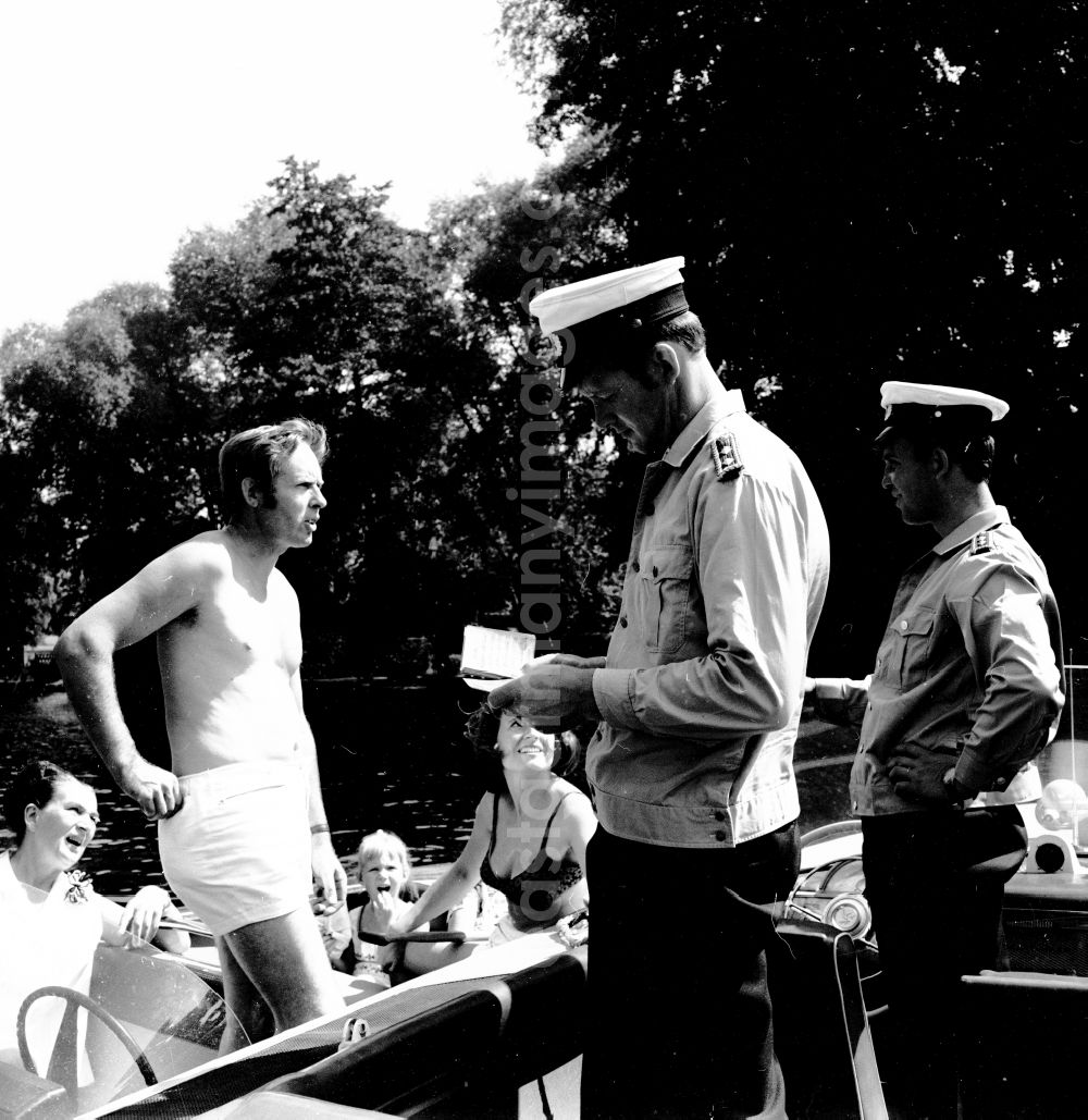 GDR photo archive: Berlin - Water police officers check the correctness of the documents of the boatmen in Berlin, the former capital of the GDR, German Democratic Republic