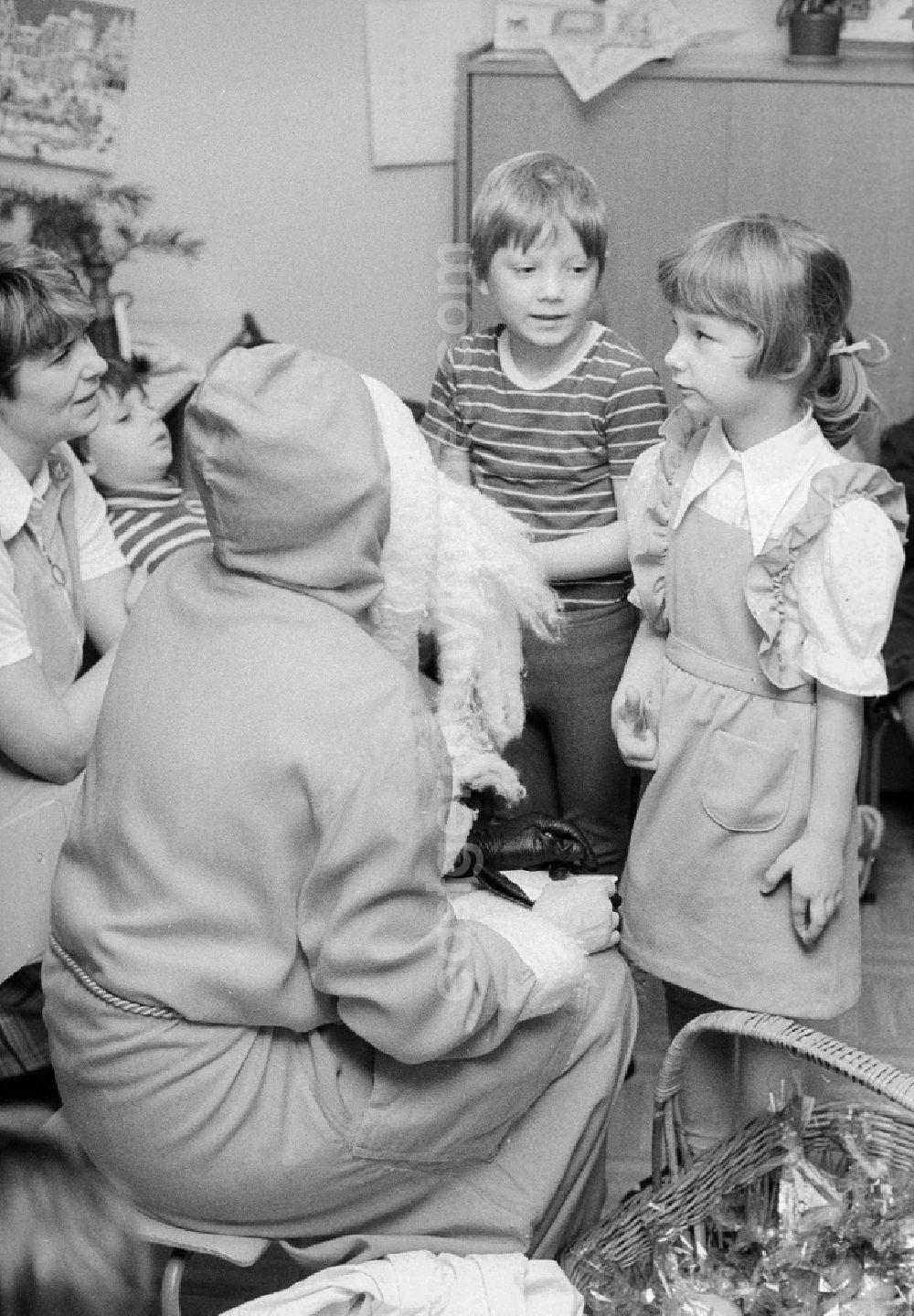 GDR photo archive: Berlin - The Santa Claus gives children with presents in a kindergarten in Berlin, the former capital of the GDR, German democratic republic