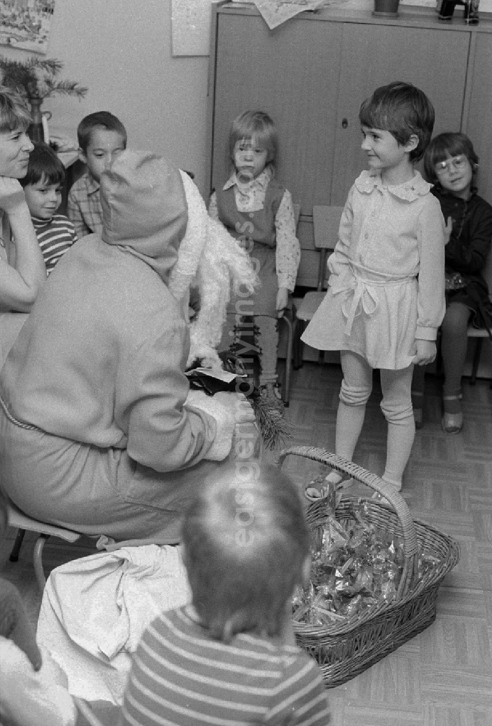 GDR photo archive: Berlin - The Santa Claus gives children with presents in a kindergarten in Berlin, the former capital of the GDR, German democratic republic