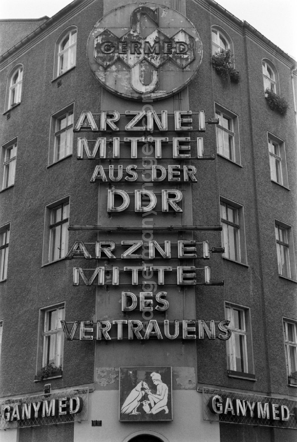 GDR photo archive: Berlin - Advertisement for GERMED - drugs from the GDR is located above the closed wine restaurant Ganymed at Schiffbauerdamm in Berlin - Mitte, the former capital of the GDR, German Democratic Republic