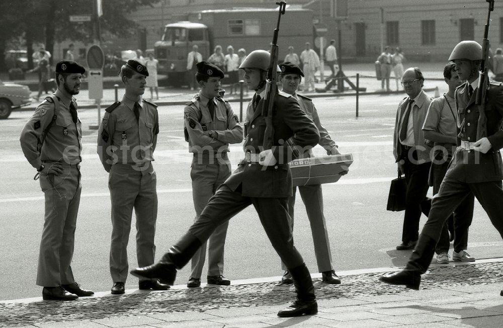 GDR photo archive: Berlin - Soldiers of the Western Allied occupying power watch the Great Guard Procession in front of the Schinklelsche Wache Unter den Linden in the Mitte district of Berlin East Berlin in the territory of the former GDR, German Democratic Republic