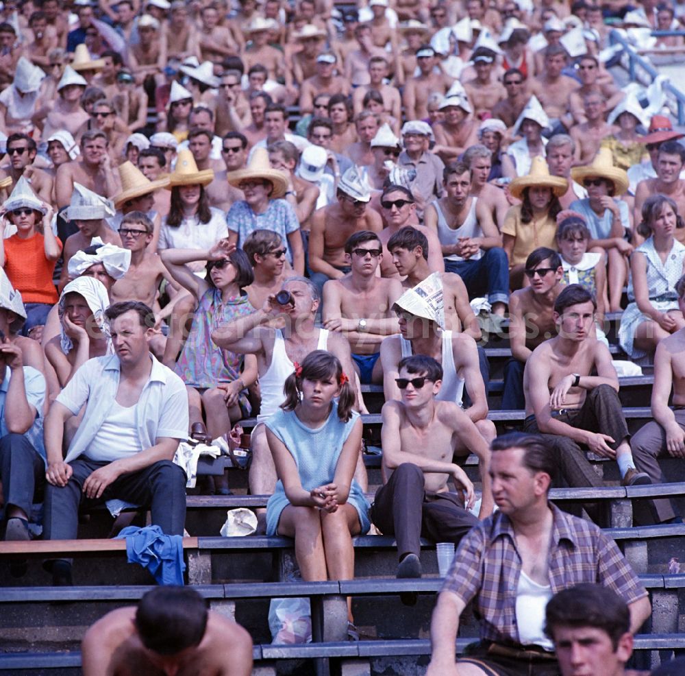 GDR photo archive: Leipzig - Spectators sit in the stands in Leipzig's Central Stadium during the V. Gymnastics and Sports Festival of the GDR from 24 to 27