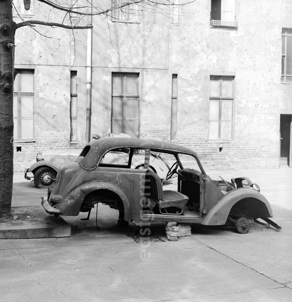 GDR photo archive: Berlin - Two old rusted car bodies on the roadside in Berlin, the former capital of the GDR, German Democratic Republic
