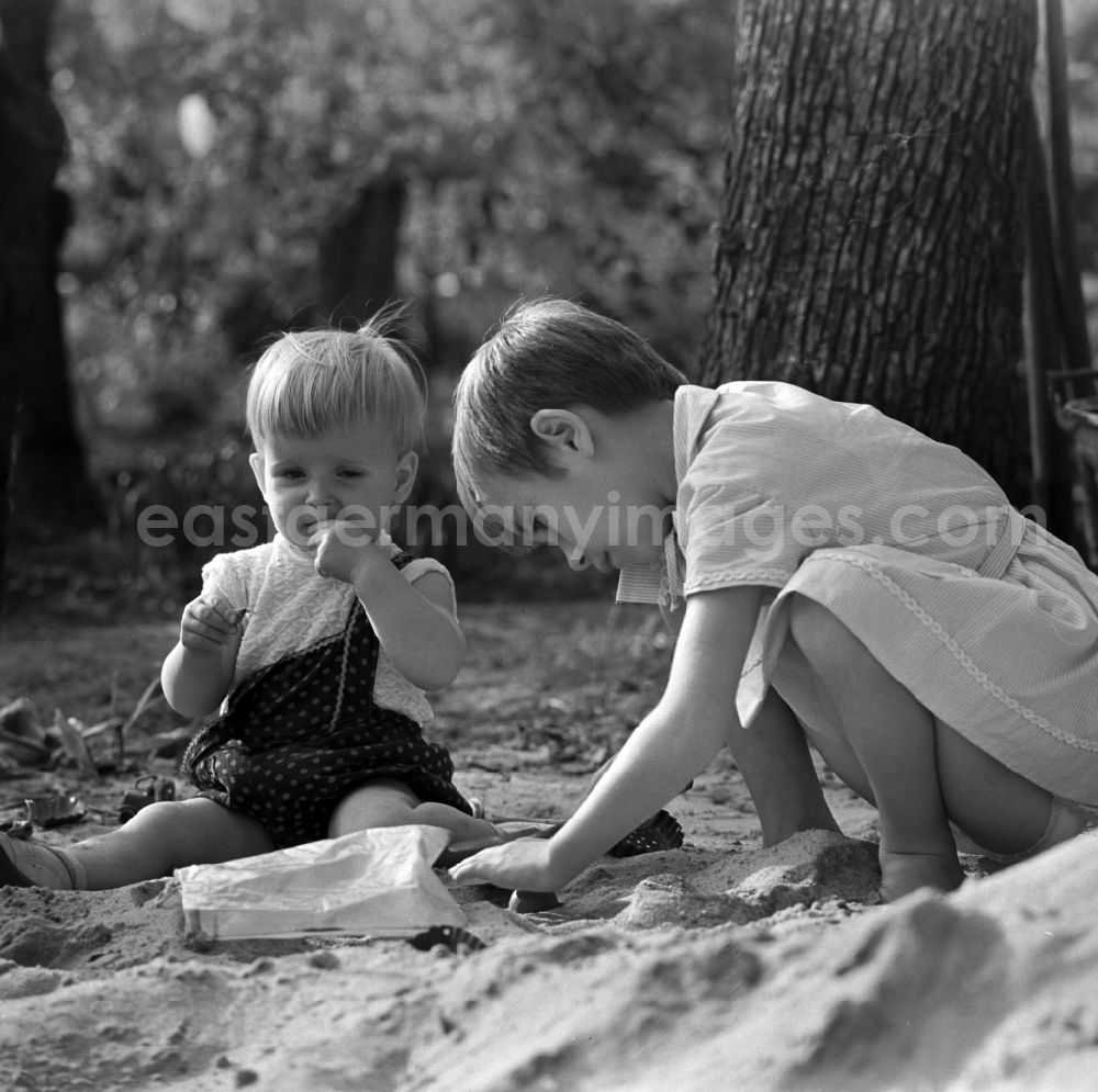 Warnemünde: Two children playing in the sand in Warnemünde in Mecklenburg - Western Pomerania