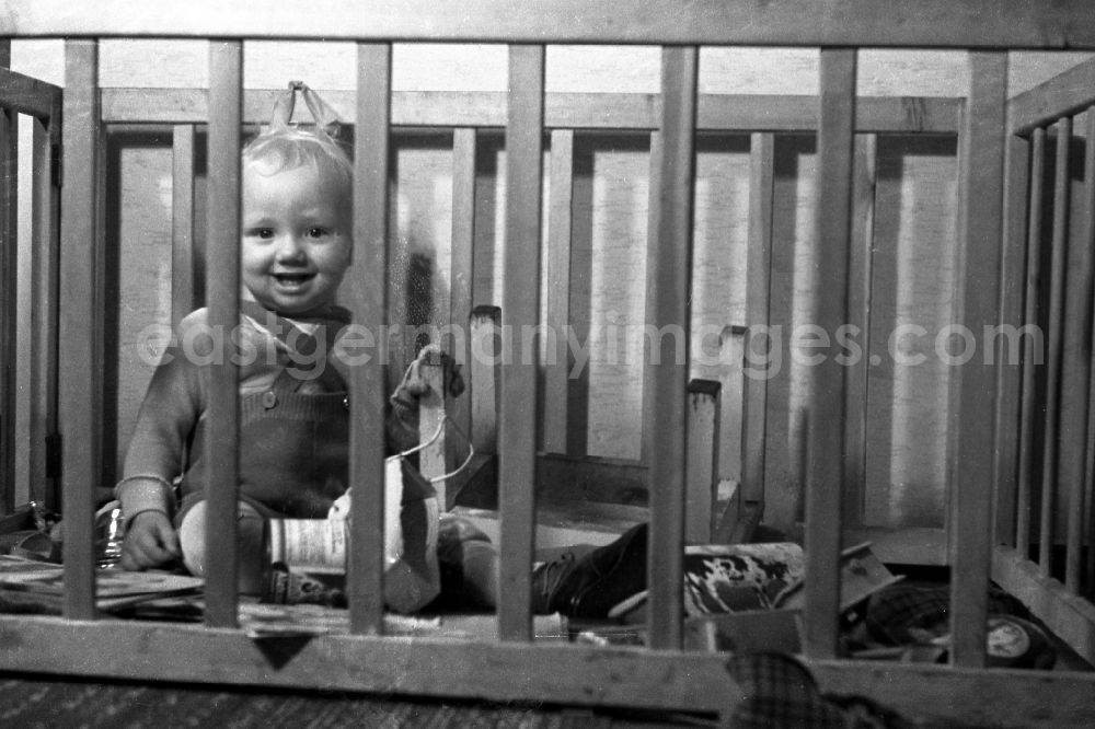 Merseburg: The big sister plays with her smaller brother in the playpen in Merseburg in the federal state Saxony-Anhalt in Germany