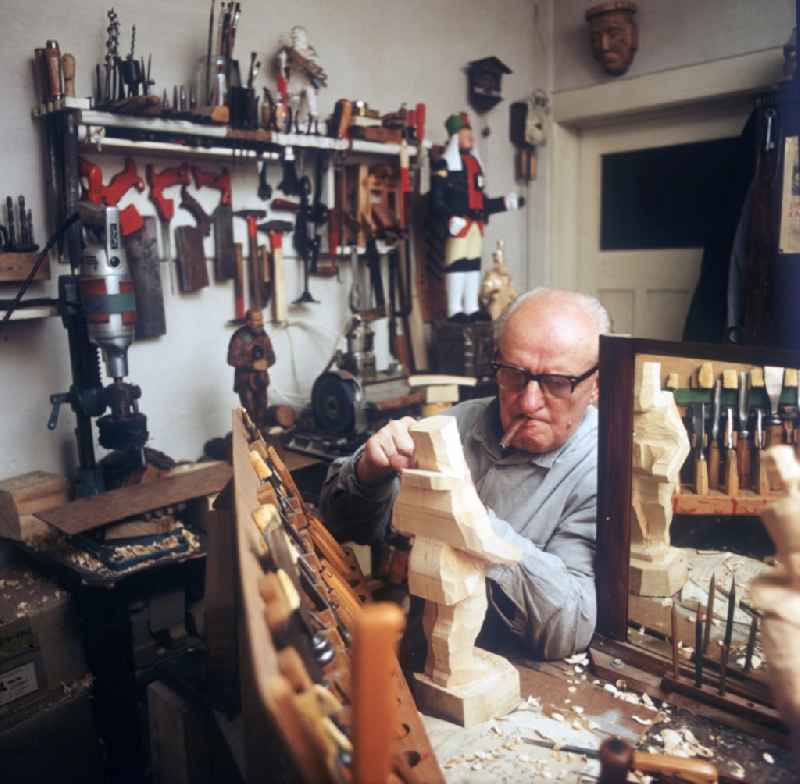 Woodcarving in the Erzgebirge. Wood sculptor in the workshop at work