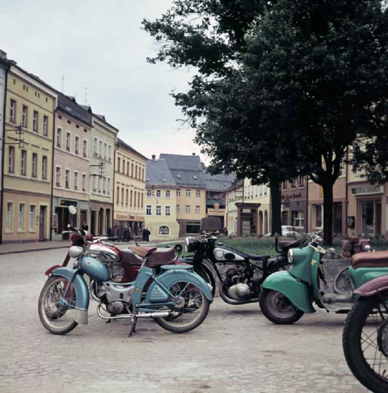 Mopeds, scooters and motorcycles park at the market in Bad Lobenstein, Thuringia in the territory of the former GDR, German Democratic Republic