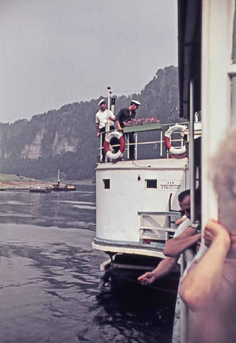 Passenger ship for passenger transport - paddle steamer sailing on the Elbe in Bad Schandau, Saxony in the territory of the former GDR, German Democratic Republic