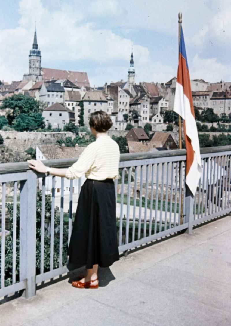 Woman on bridge on historic old town in the center in Bautzen in the state Saxony on the territory of the former GDR, German Democratic Republic