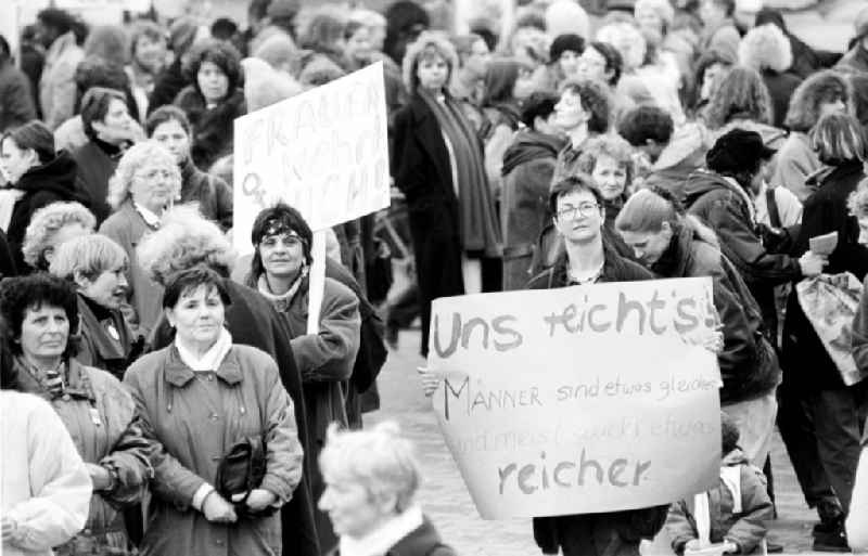 Women demonstrate on Women's Day in front of the Red City Hall in Berlin. Demonstrators demonstrate and hold placards