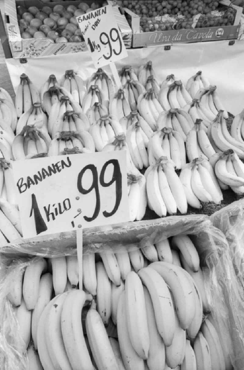 Sale of bananas at a market stall. Price tags indicate the price,