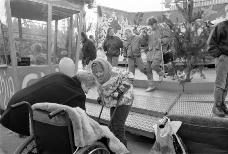 Disabled children in front of a carousel at a Christmas market in Berlin-Mitte