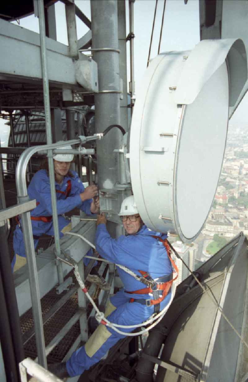 Technicians during maintenance and repair work during external work on the antenna support of the Berlin TV tower in the Mitte district of Berlin East Berlin