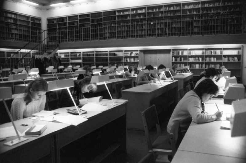 View into the reading room of the Humboldt University, students sit at tables and learn, study and read in the center of Berlin, the former capital of the GDR, German Democratic Republic