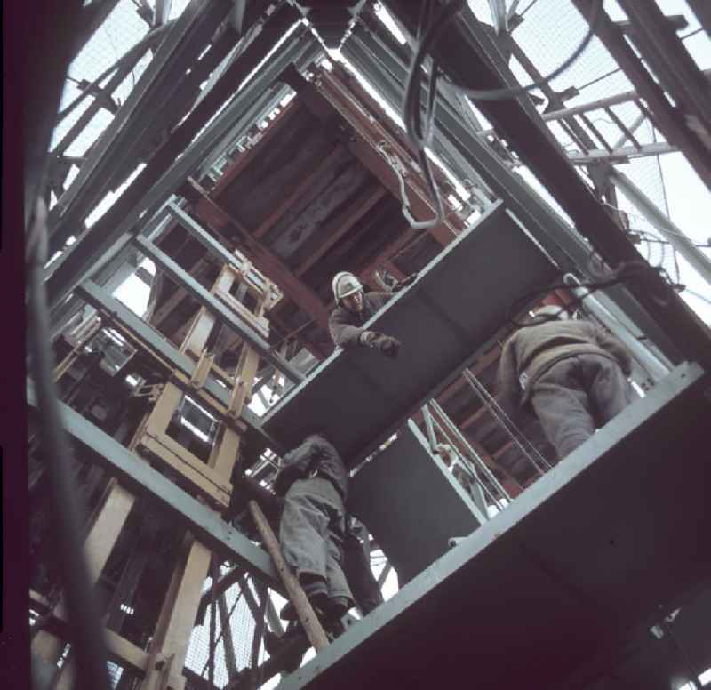 Bauarbeiter bei der Montage im Stahlskelett des Fernsehturm in Berlin.