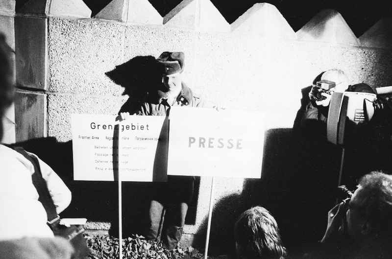 A soldier of the Border Troops of the GDR presented to the media representatives and journalists attending a press badge  By Baupioniere and soldiers of the Border Troops of the GDR L-profiles were removed from the ramparts of the GDR border to West Berlin
