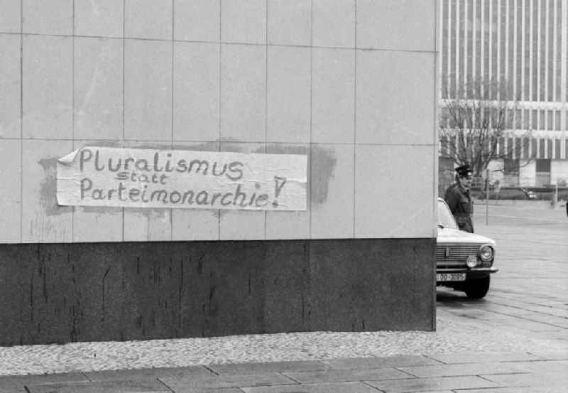 A protest slogan 'pluralism instead of party monarchy' sticks on the facade of the building of the GDR State Council on the Marx-Engels-Platz