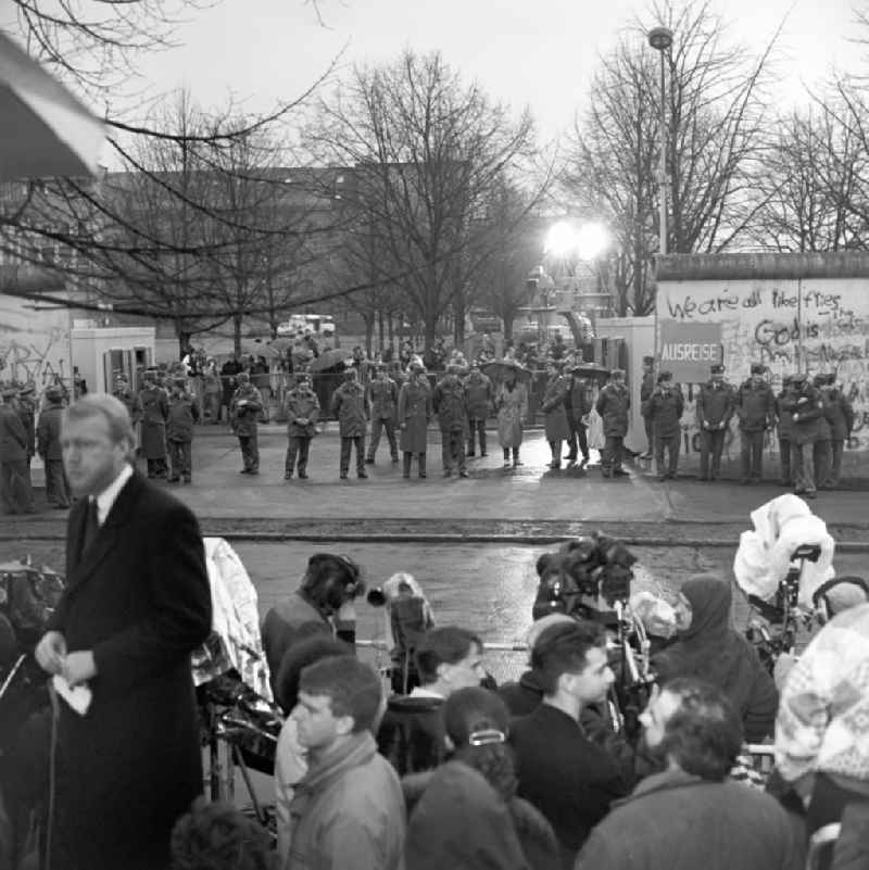 Happening around the Brandenburg Gate shortly before the opening on the occasion of the Berlin Wall in November 1989 in Berlin. View over Members of the press on West German FRG and East German GDR border police before an open part of the wall at the Brandenburg Gate