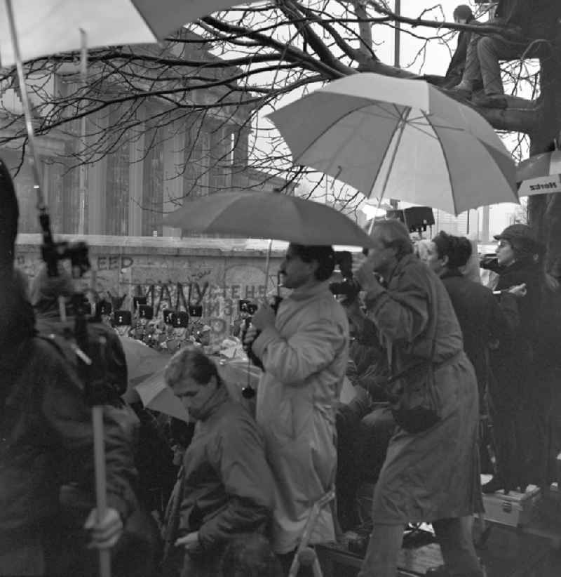 Happening around the Brandenburg Gate during the wall opening at the Berlin Wall fell in November 1989 in Berlin. Members of the press before an open section of wall at the Brandenburg Gate