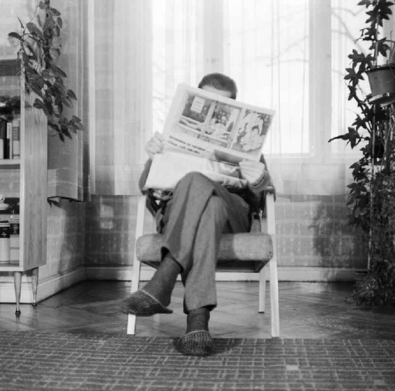 Man read a newspaper in a chair in Berlin