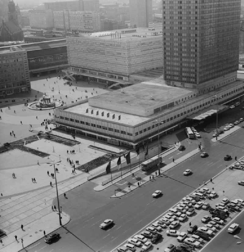 View at the Alexanderplatz in Berlin - Mitte. In the foreground the Hotel Stadt Berlin (now known as Park Inn by Radisson), behind the Centrum department store (now Galeria Kaufhof) next to the Alexander House and the S- and U-Bahn station Alexanderplatz. Centrally located in the middle of Alexanderplatz find the Fountain of Friendship of Nations