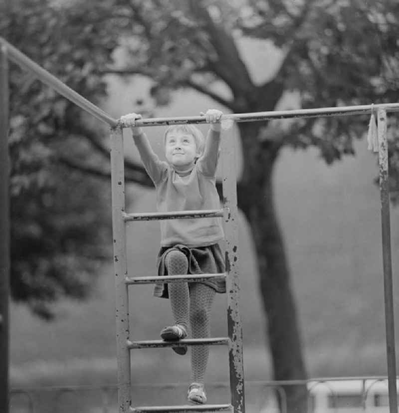 Child climbs on a jungle gym in Berlin