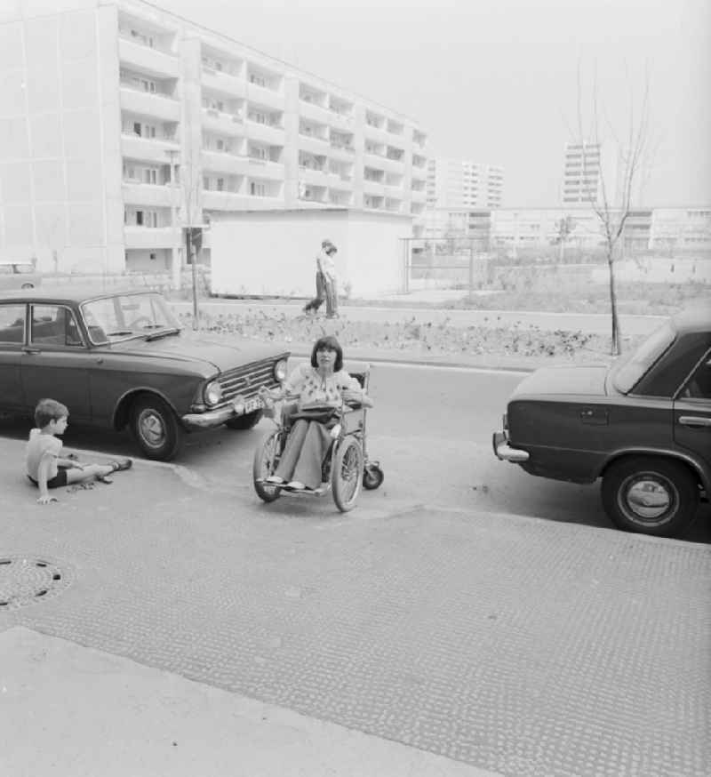 A wheelchair user moves accessible on the street in Berlin-Marzahn