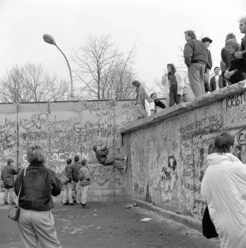 Young people and tourists on the Berlin Wall in Berlin