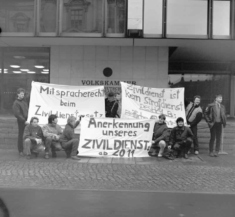 Young men demonstrate in front of the parliament of the GDR in Berlin for the recognition of their community service