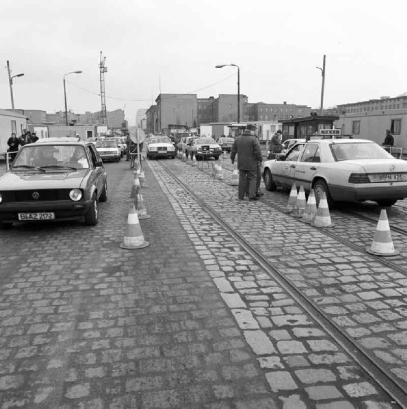 East German border guards check the provisional transition Potsdamer Platz West German cars