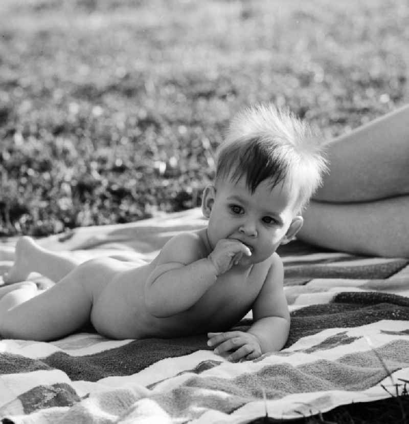 Small child naked on a blanket in Berlin