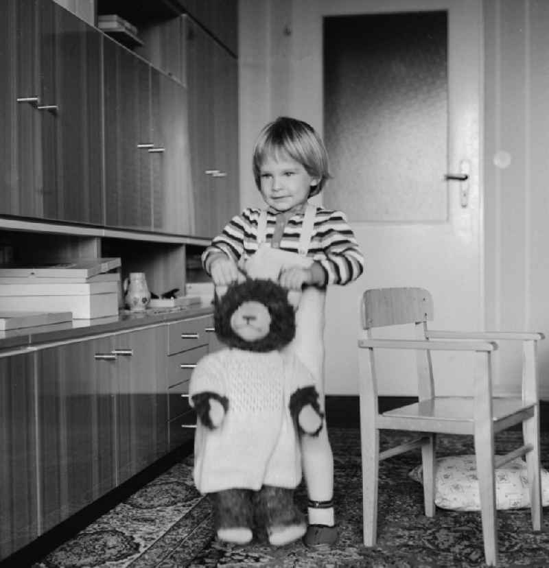 Small child playing with his teddy in Berlin