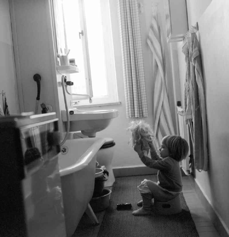 Small child sits in the bathroom on his potty in Berlin