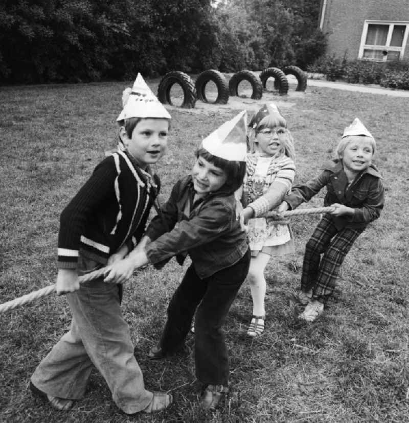 Children at the tug of war in nursery school in Berlin