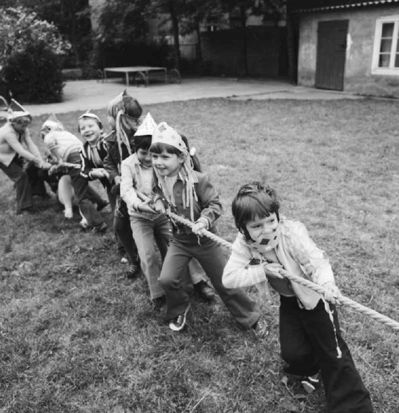 Children at the tug of war in nursery school in Berlin